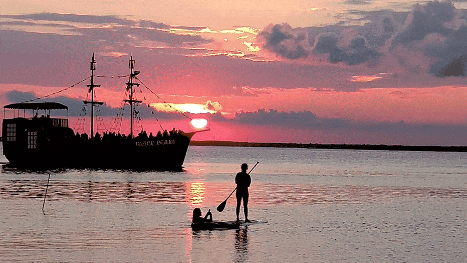 The Black Pearl and a paddleboarder at sunset. North Beach Haven